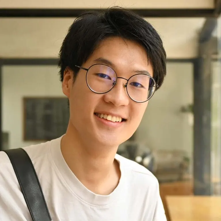 Melbourne Tech Institute student in glasses holding course books